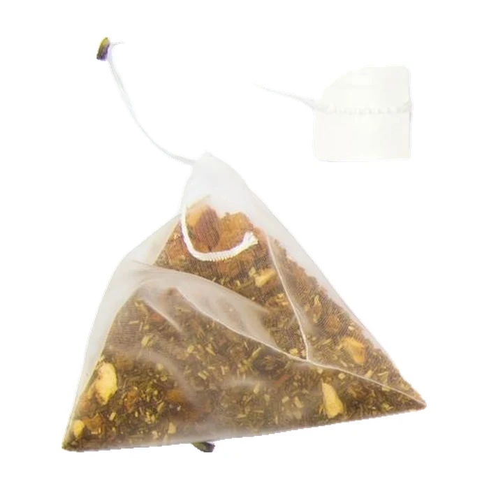 Sachet de thé pyramidal rempli d’un mélange botanique, présenté avec son fil et une étiquette vierge