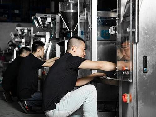 Technicians working on packaging machinery
