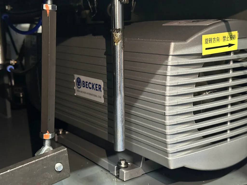 Becker vacuum pump component installed inside a rotary pouch packing machine.